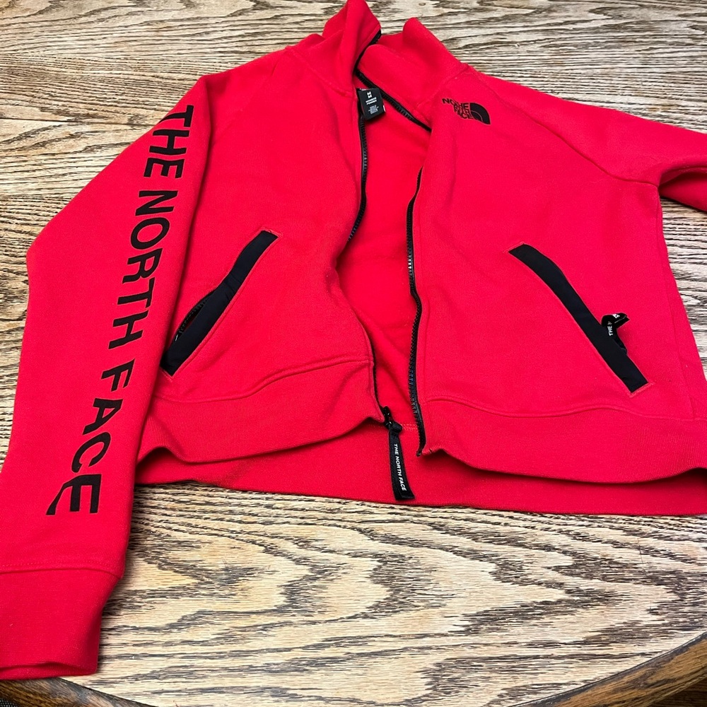 The North Face women’s jacket. Red with black lettering and zippers